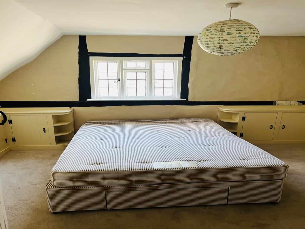 Large bed and bedroom furniture prepared for removal during a Maidenhead home move